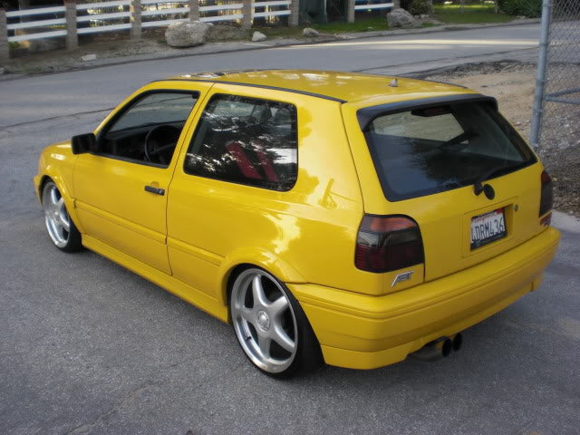 Yellow 1999 VW GTI VR6, rear driver-side three-quarter view