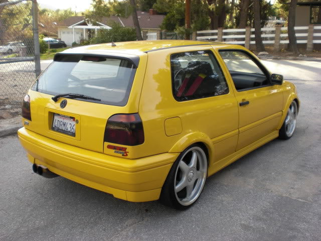 Yellow 1999 VW GTI VR6, rear passenger-side three-quarter view